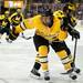 Michigan Tech defenseman Walker Hyland tries to get loose from a Michigan player at Joe Louis Arena on Saturday, Dec. 29. Daniel Brenner I AnnArbor.com